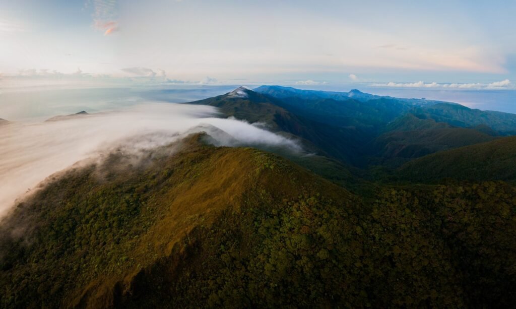 Scenic mountain range with lush green peaks and low-lying clouds