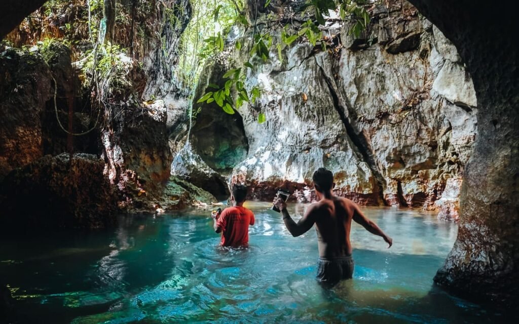 Travelers exploring tayangban cave pool